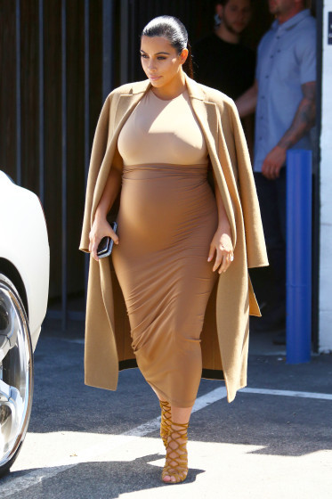 Kim Kardashian flaunts her growing baby bump in a form fitting two-tone dress